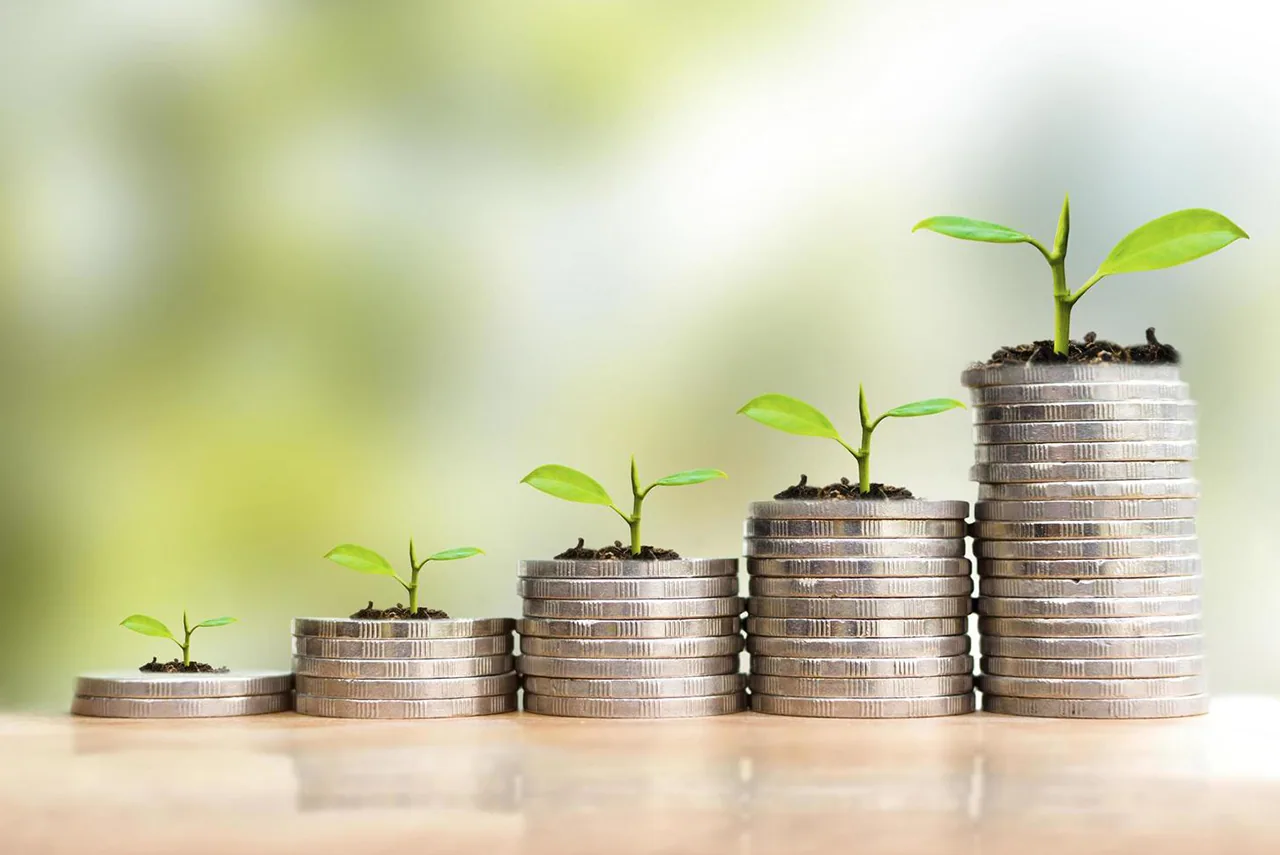 Stacks of coins with seedlings growing from them, rising left to right.